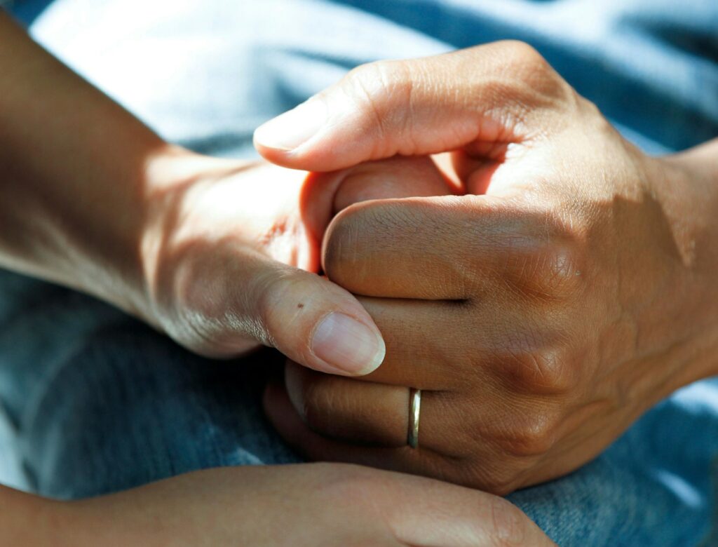 person wearing gold wedding band